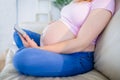 Pregnant woman looking at ultrasound scans and touching her belly Royalty Free Stock Photo