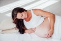 A pregnant woman is lying in bed waiting for the birth of a child Royalty Free Stock Photo