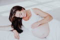 A pregnant woman is lying in bed waiting for the birth of a child Royalty Free Stock Photo