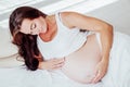 A pregnant woman is lying in bed waiting for the birth of a child Royalty Free Stock Photo