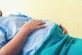 Pregnant woman lying on the bed waiting to give birth in a hospital
