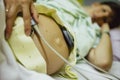 Pregnant woman lying in a hospital bed with baby heartbeat monitor on her belly Royalty Free Stock Photo