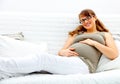 Pregnant woman lying on sofa and holding her belly Royalty Free Stock Photo