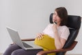 Pregnant woman makes a purchase on the Internet Royalty Free Stock Photo