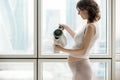 Pregnant woman making cup of hot drink Royalty Free Stock Photo