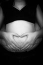 Pregnant woman making heart shape with hands