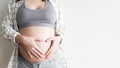 Pregnant woman making heart sign on belly Royalty Free Stock Photo