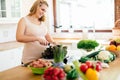 Pregnant woman making a meal in kitchen Royalty Free Stock Photo