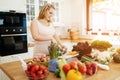 Pregnant woman making a meal in kitchen Royalty Free Stock Photo