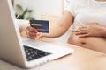 Pregnant Woman making online shopping on laptop at home Royalty Free Stock Photo