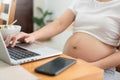 Pregnant Woman making online shopping on laptop at home Royalty Free Stock Photo