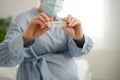 Pregnant woman making test. Close up of fingers holding express antigen covid test, negative result