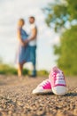 Pregnant woman and man baby shoes. Selective focus Royalty Free Stock Photo