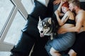Pregnant woman, man and dog lying on a bed Royalty Free Stock Photo