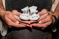 Pregnant woman and man holding baby shoes Royalty Free Stock Photo