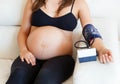 Pregnant woman measures the blood pressure