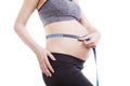 Pregnant woman measures her belly with a measure Royalty Free Stock Photo