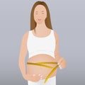 A pregnant woman measures her belly with Royalty Free Stock Photo