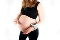 Pregnant woman measures her blood pressure with wrist tonometer heart rate level Royalty Free Stock Photo