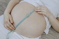 Woman measuring their belly. Royalty Free Stock Photo