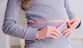 Pregnant woman measuring belly with centimeter Royalty Free Stock Photo