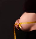 Pregnant woman measuring her abdomen Royalty Free Stock Photo