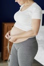 Pregnant woman measuring her abdomen Royalty Free Stock Photo