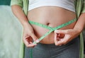 Pregnant woman measuring her belly with tape measure Royalty Free Stock Photo