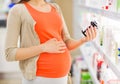 Pregnant woman with medication at pharmacy