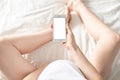 Pregnant woman with mobile phone in her hands in her bedroom . Motherhood , using technology and love Royalty Free Stock Photo