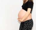 Pregnant woman model touching her pregnancy belly abdomen, isolated on white background Royalty Free Stock Photo