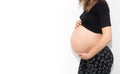 Pregnant woman model touching her pregnancy belly abdomen, isolated on white background Royalty Free Stock Photo
