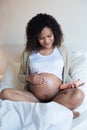 Pregnant woman moisturizing belly