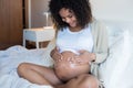 Pregnant woman moisturizing belly