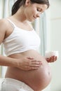 Pregnant Woman Moisturizing Belly