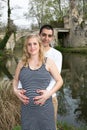 Pregnant woman mother with man father touching her belly with hands in dress pregnancy maternity concept Royalty Free Stock Photo