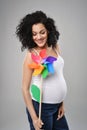 Pregnant woman with multicolored pinwheel windmill Royalty Free Stock Photo