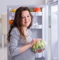 Pregnant woman near fridge looking for food and snacks Royalty Free Stock Photo