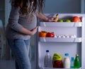 Pregnant woman near fridge looking for food and snacks at night Royalty Free Stock Photo