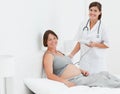 Pregnant woman with a nurse smilling