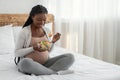 Pregnant Woman Nutrition. Happy Black Expecting Lady Eacting Vegetable Salad In Bed