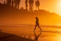 Pregnant woman on ocean beach at beach with sunrise or sunset Royalty Free Stock Photo