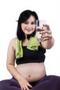 Pregnant woman offering water Royalty Free Stock Photo