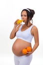 Pregnant woman and oranges and fresh juice. Isolated on white background