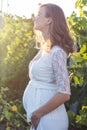 Pregnant woman outdoors in sunset lights Royalty Free Stock Photo