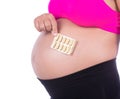 pregnant woman with pack of pills in her hands on white background Royalty Free Stock Photo