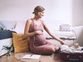 Pregnant woman packing bag for maternity hospital, making notes, checking list in diary. Expectant mother with suitcase of baby Royalty Free Stock Photo