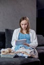 Pregnant woman packing bag for maternity hospital, making notes, checking list in diary. Expectant mother with suitcase Royalty Free Stock Photo