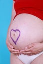 Pregnant woman with painted heart