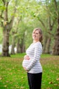 Pregnant woman playing yoga at the Hyde Park, London